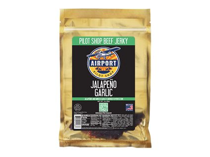Spicy Jalapeno Garlic Beef Jerky on a wooden cutting board, perfect for those who love a bold and garlicky taste in a convenient on-the-go snack